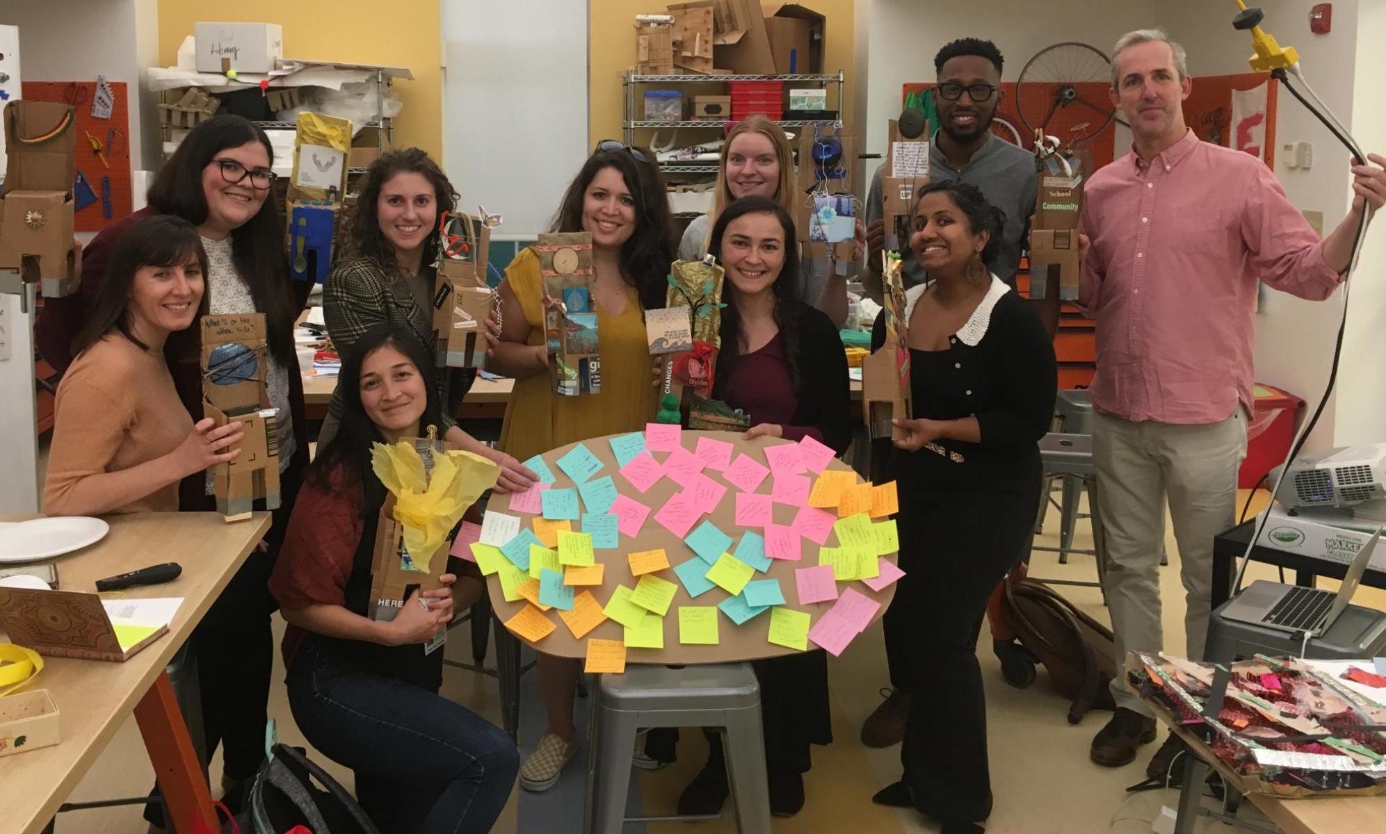 Participants showing off their maker creations in a group photo.