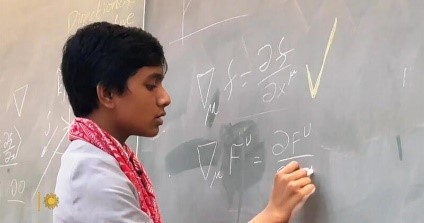 A person writing on a chalkboardDescription automatically generated