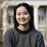 A woman smiles at the camera