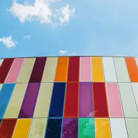 Glass windows on a building set against a blue sky