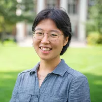 A woman smiles at the camera