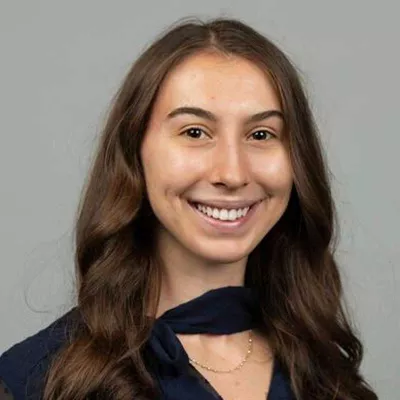 A woman smiles at the camera