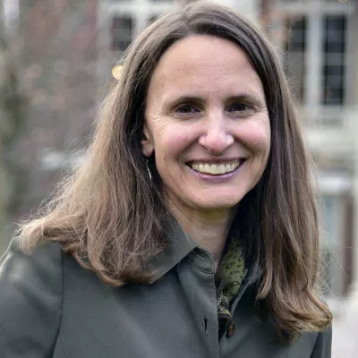 A woman smiles at the camera