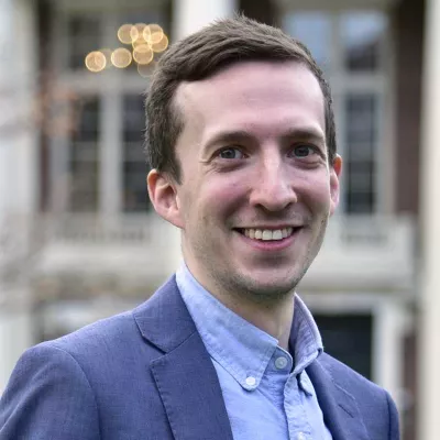 A man smiles at the camera