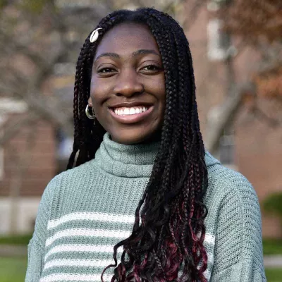A woman smiles at the camera