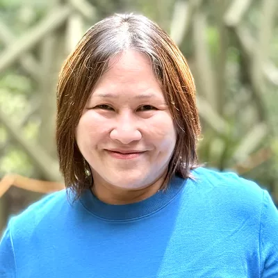 A woman smiles at the camera