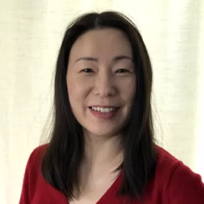 A woman smiles at the camera