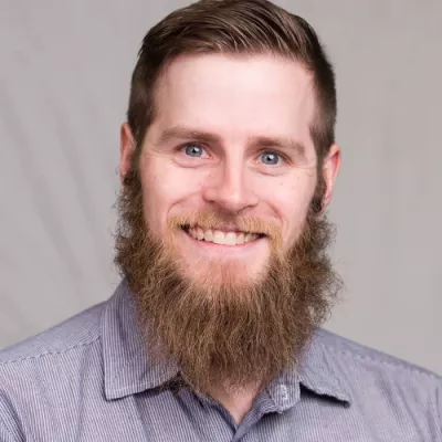 A man smiles at the camera