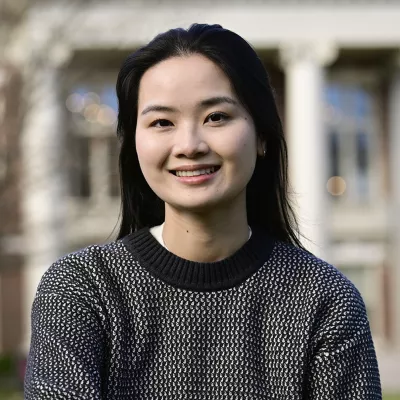 A woman smiles at the camera