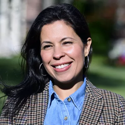 A woman smiles at the camera