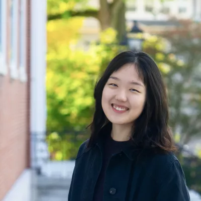 A woman smiles at the camera