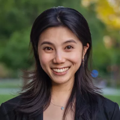 A woman smiles at the camera