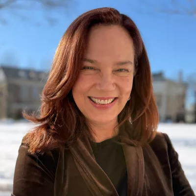 A woman smiles at the camera