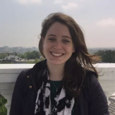 A woman smiles at the camera