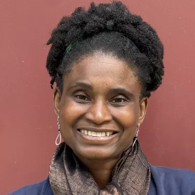 A woman smiles at the camera