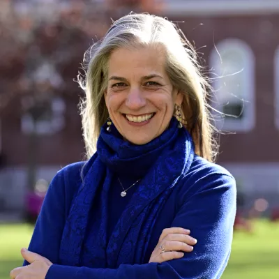 A woman smiles at the camera