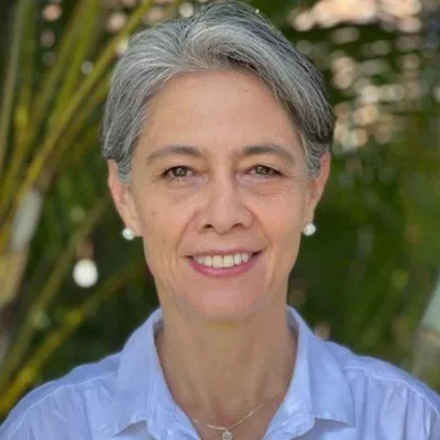 A woman smiles at the camera