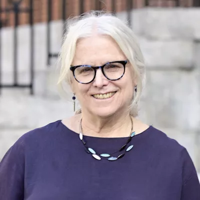 A woman smiles at the camera