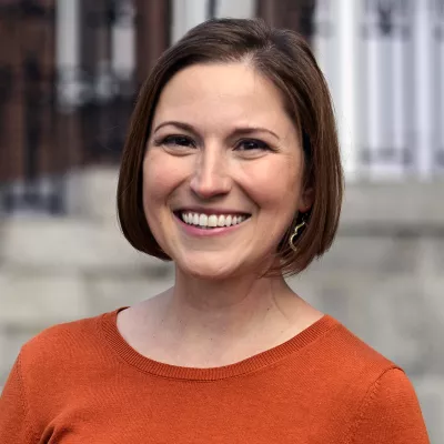 A woman smiles at the camera