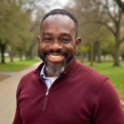 A man smiles at the camera