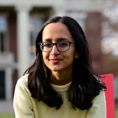 A woman smiles at the camera