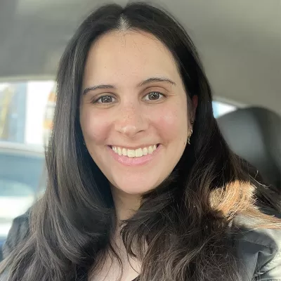 A woman smiles at the camera