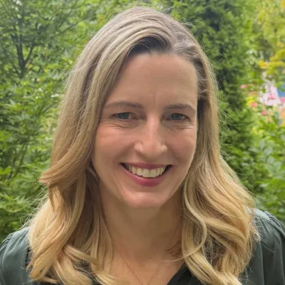 A woman smiles at the camera