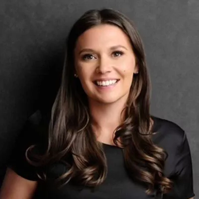 A woman smiles at the camera