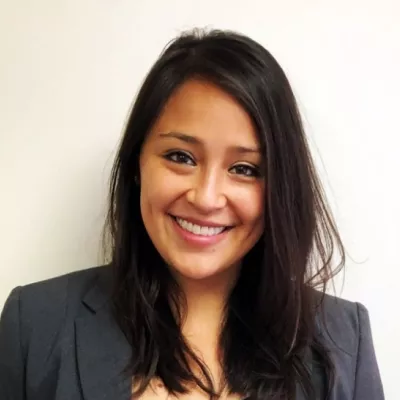 A woman smiles at the camera