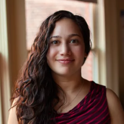 A woman smiles at the camera