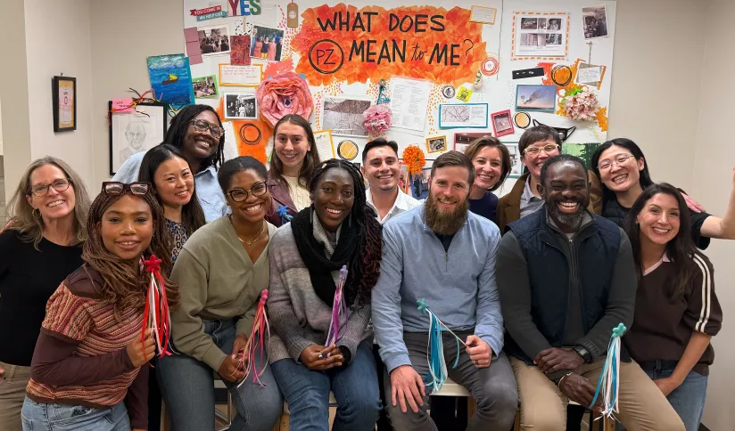 A group of adults smiles and poses