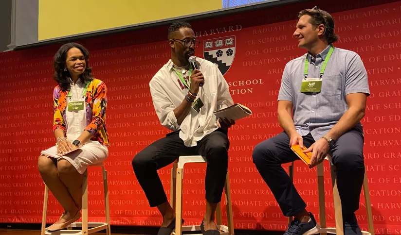 Three people present at a conference