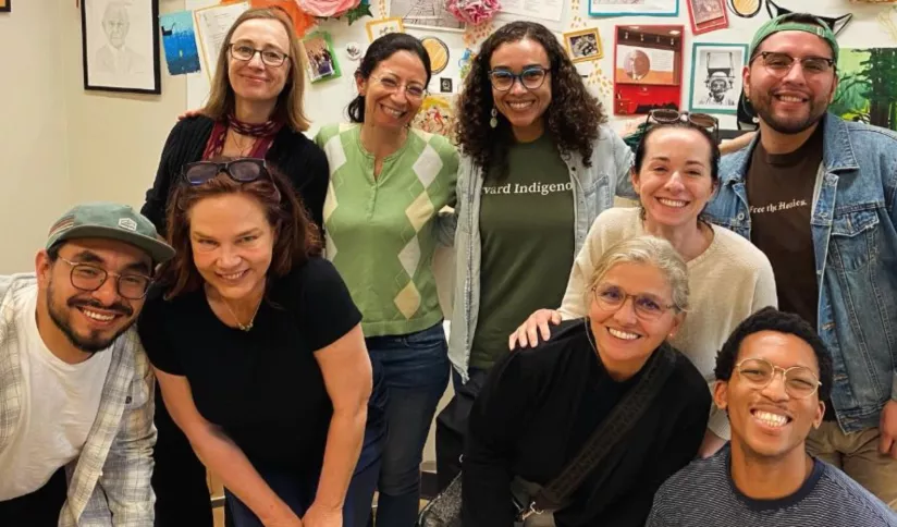 A group of adults smiles and poses