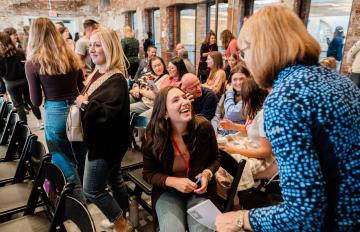 Women greet each other at a conference